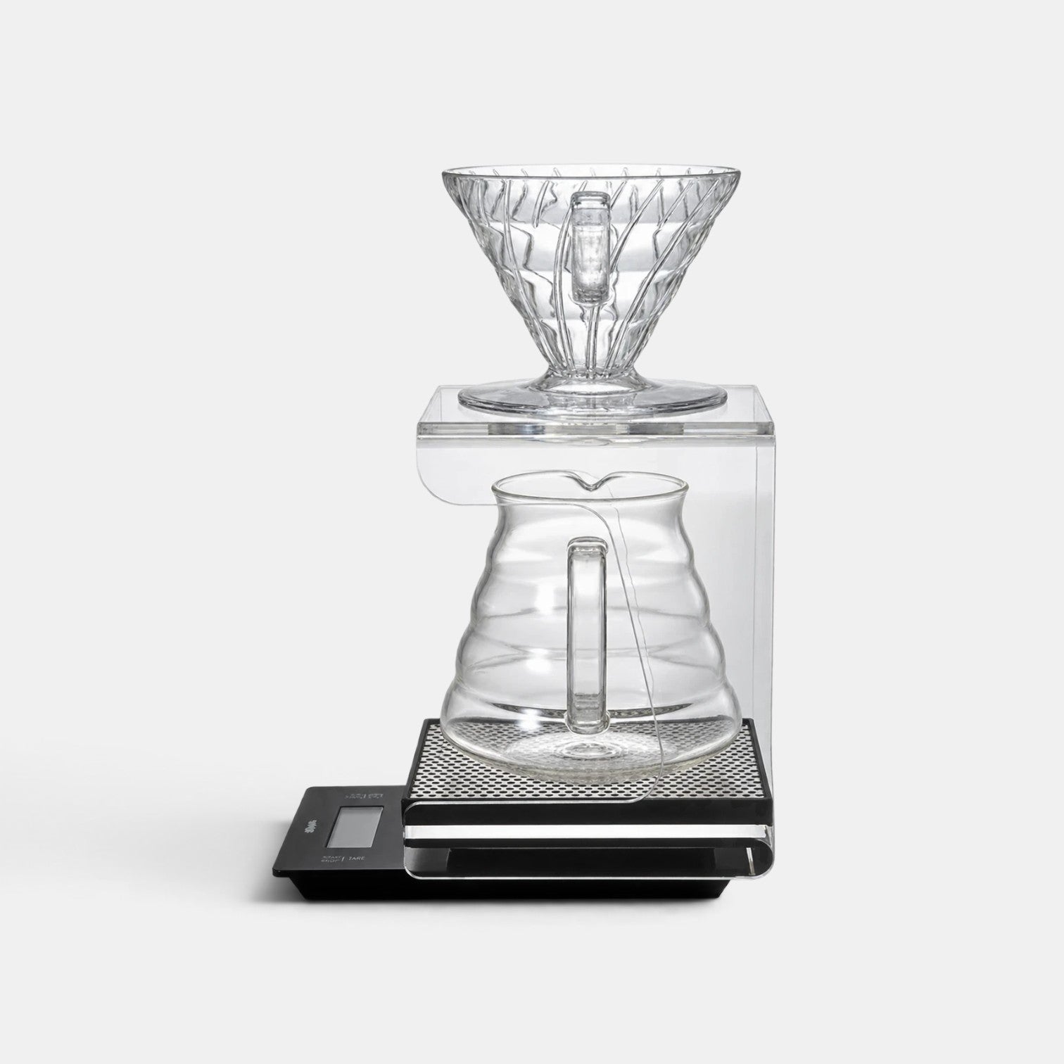 Bootlegger Coffee Hario V60 acrylic drip station with a clear glass dripper and carafe on a black digital scale.