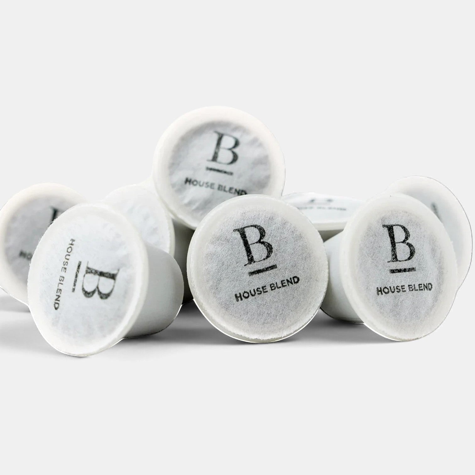 Bootlegger Coffee House Blend coffee capsules in a white pile on a clean background