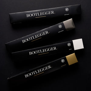 Bootlegger Coffee House Blend and other coffee capsule boxes in black packaging on a dark background
