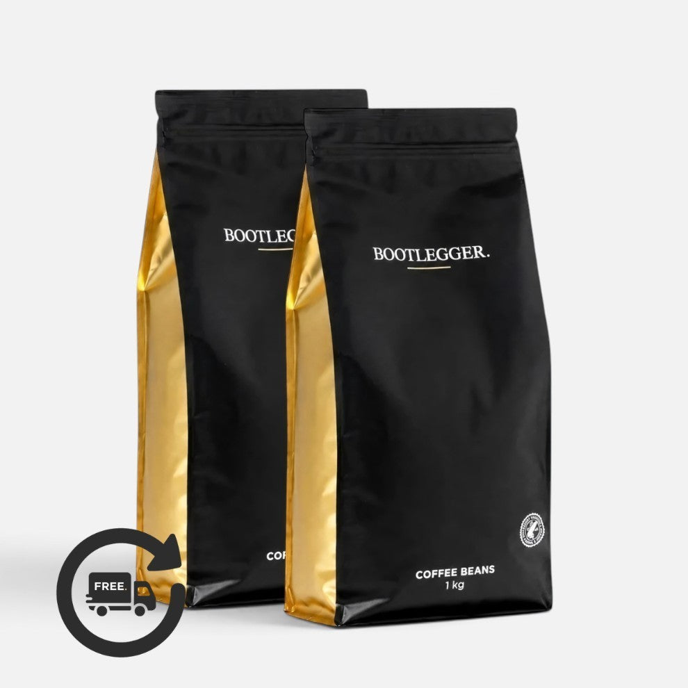 Two 1kg bags of Bootlegger Coffee House Blend coffee beans in black and gold packaging with a free delivery icon