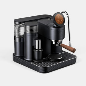 Bootlegger Coffee Meraki espresso machine in matte black with a wooden portafilter handle and digital touch display.