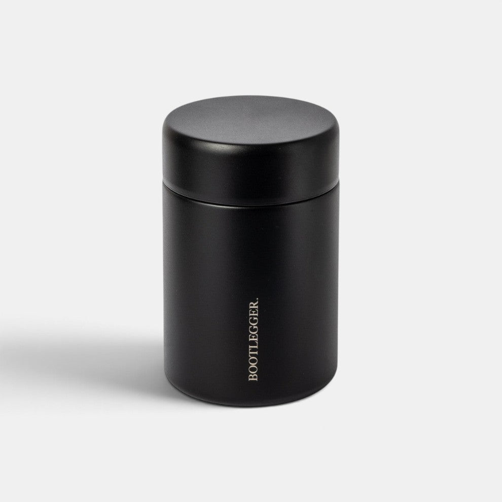 Matte black MiiR X Bootlegger Coffee canister with a minimalist cylindrical design and white logo branding.