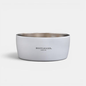 Bootlegger Coffee white stainless steel MiiR dog bowl with Buddy Club branding on a black background