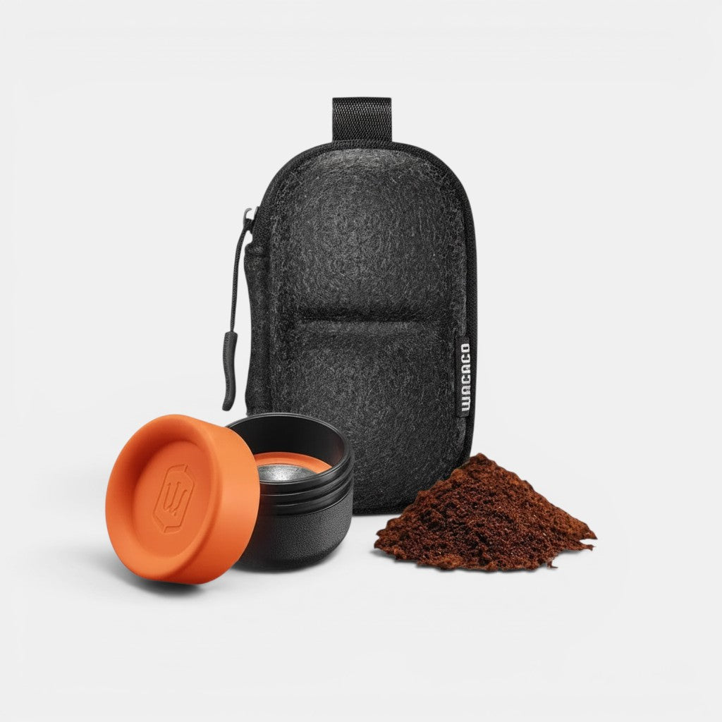 Bootlegger Coffee Wacaco Minipresso GR2 espresso maker parts with orange cap, filter basket, and coffee grounds in case