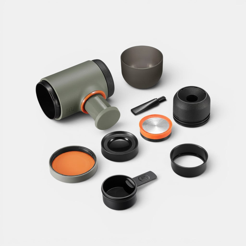 Bootlegger Coffee Wacaco Minipresso GR2 portable espresso maker with olive green body, orange accents, and accessories.